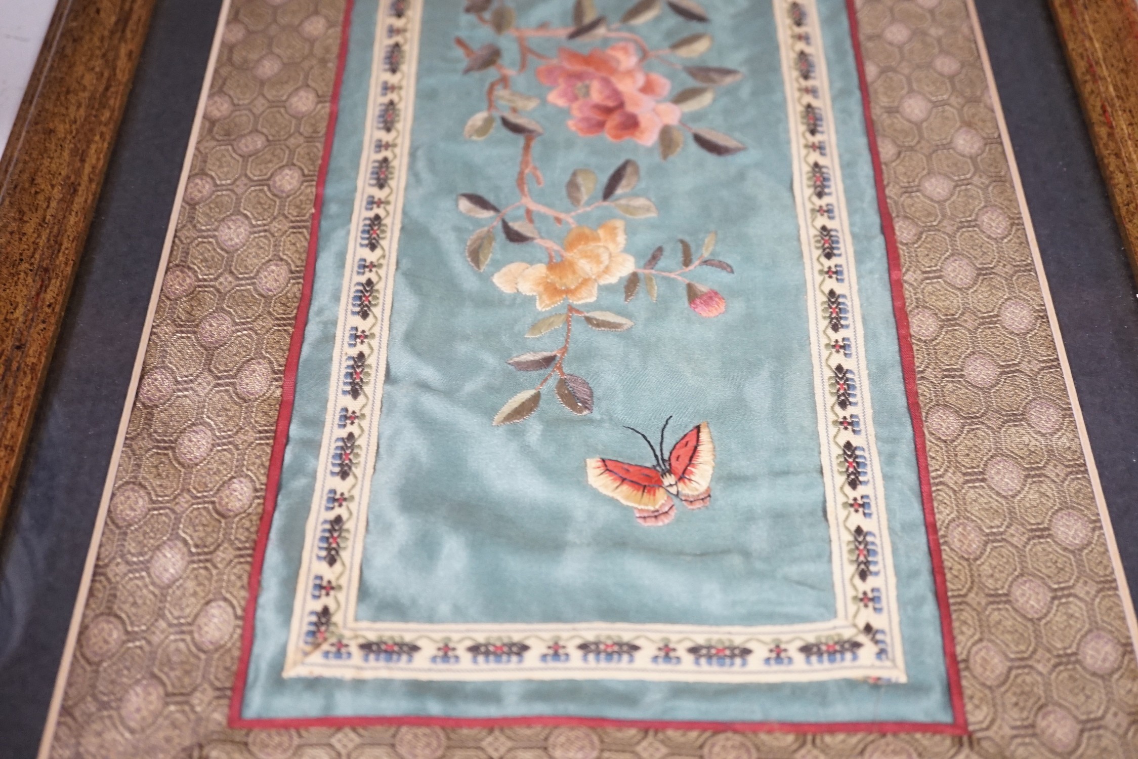 A pair of framed Chinese embroideries with bird and flower decoration, 34 x 14cm